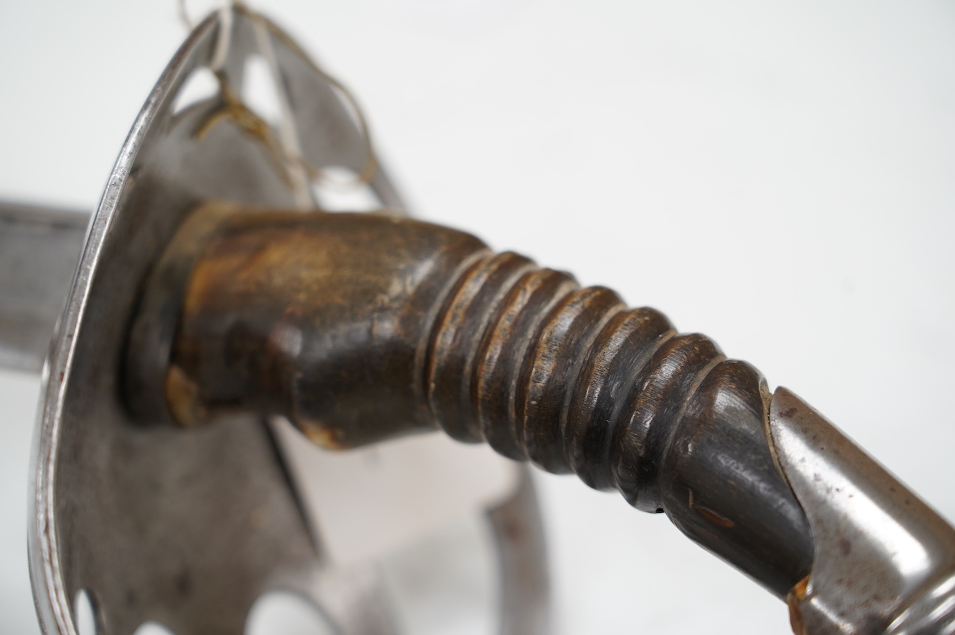 An 1880s French cavalry sword with horn grip and seven bar pierced steel guard, blade 88cm. Condition - fair